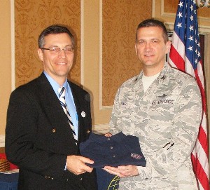 Col. Glenn Powell, USAF (r), chapter vice president, presents a chapter polo shirt to Dr. Mark Maybury, chief scientist of the U.S. Air Force, in recognition of his speech at the March meeting.